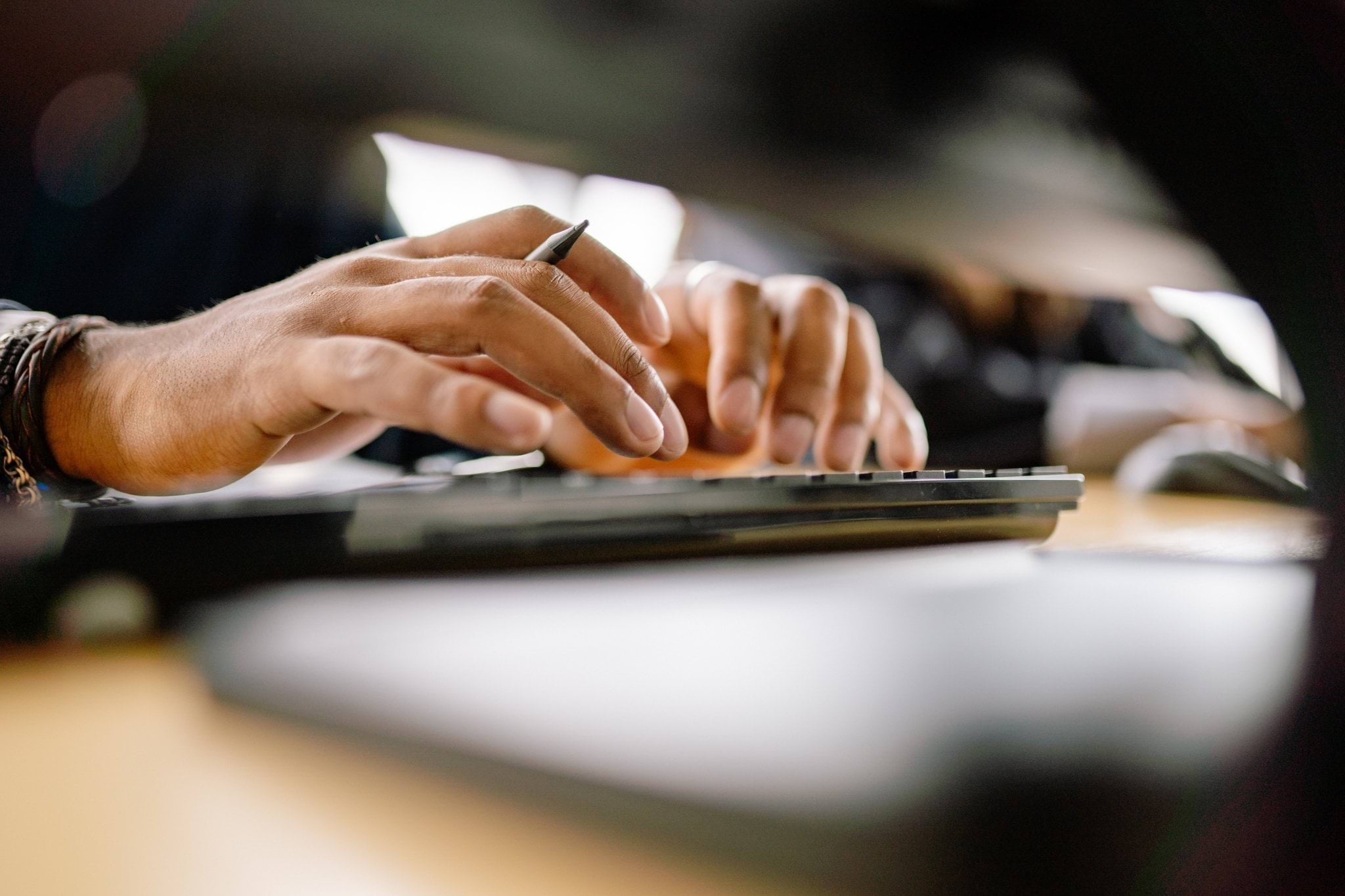 Close up of hands typing at a keyboard